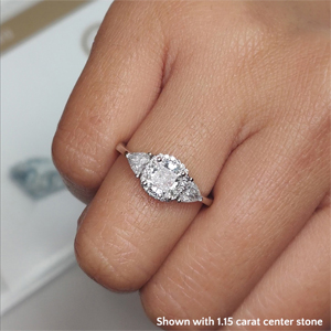 Oval engagement ring with trillion side stones hotsell