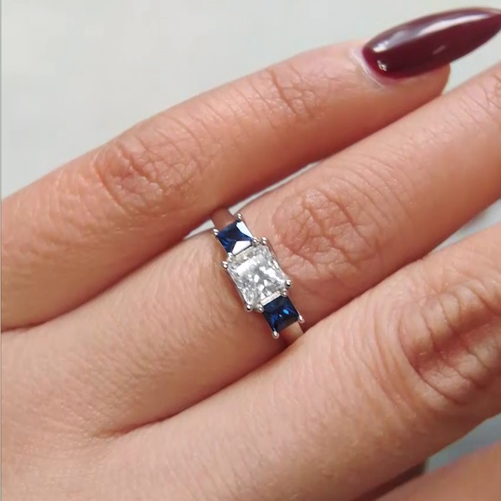 Princess Cut Trellis 3 Stone Diamond Engagement Ring With Sapphire In 950 Platinum